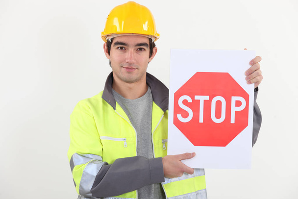 Worker with stop sign - Φωτογραφία, εικόνα