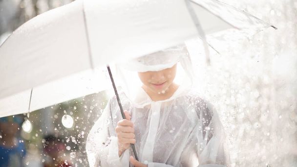 Little boy playing water drops fountain under the cloth and umbrella - Photo, Image