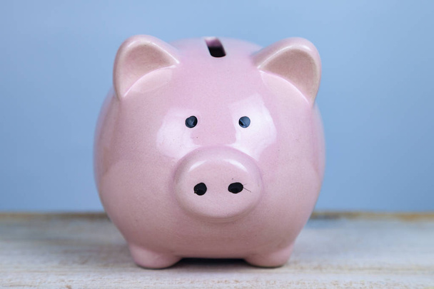 Pink pig money box on a wooden background - Zdjęcie, obraz