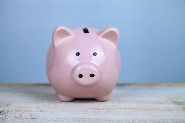 Pink pig money box on a wooden background - Foto, immagini