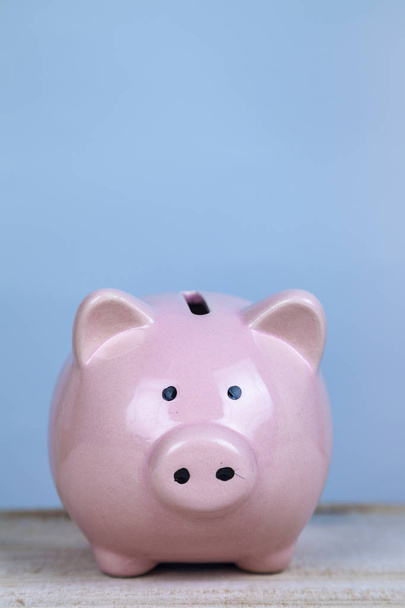 Pink pig money box on a wooden background - Zdjęcie, obraz
