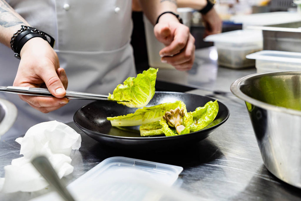 chef making salad in the restaurant - Photo, image