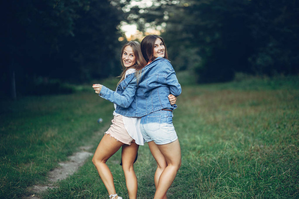 Two pretty girls in a summer park - Zdjęcie, obraz