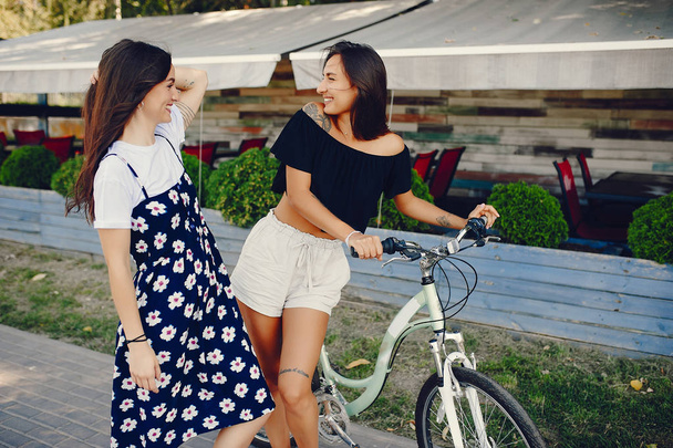 Stylish girls walking in a summer park - Fotografie, Obrázek