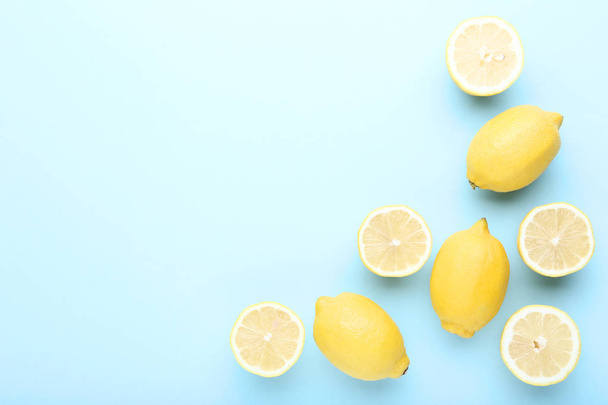 Ripe lemons on blue background - Φωτογραφία, εικόνα