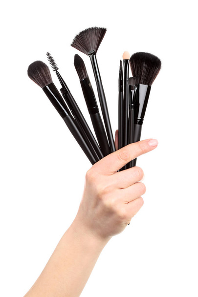 Makeup brushes in female hand on white background - Zdjęcie, obraz