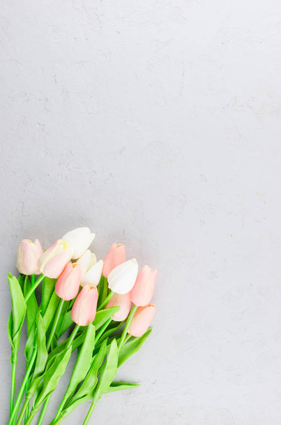 bouquet of light pink tulips on a gray concrete background - Fotoğraf, Görsel