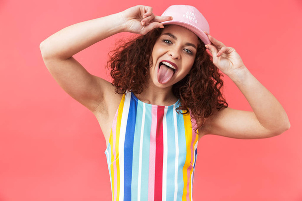 Portrait of a cheerful young woman wearing cap - Фото, зображення