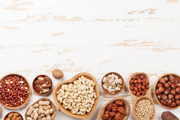 Various nuts selection on wooden table - Φωτογραφία, εικόνα