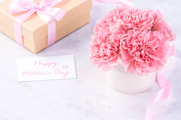 Copy space, close up, mock up, clipping path. Mothers day wording concept design. Beautiful fresh blooming baby pink color carnations isolated on bright marble background. - Fotoğraf, Görsel