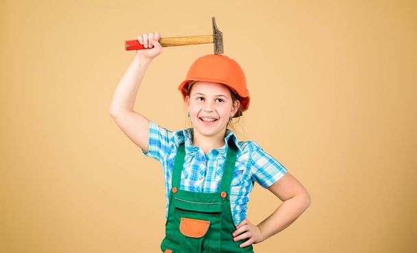 Little girl in helmet with hammer. Kid worker in hat. Labor day. 1 may. Foreman inspector. Repair. small girl repairing in workshop. Safety expert. Future profession. building is not for everyone - Фото, зображення