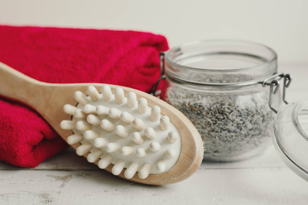 Wooden brush for body massage, scrub and red cotton towel. Dry body massage and skin exfoliating. Body care and spa treatment - Photo, Image