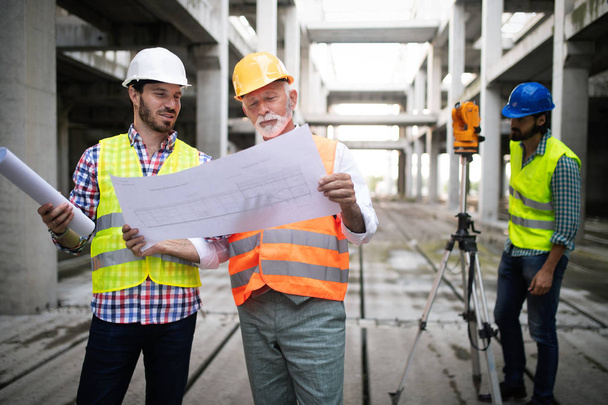 Team of business people in group, architect and engeneer on construciton site check documents - Fotoğraf, Görsel