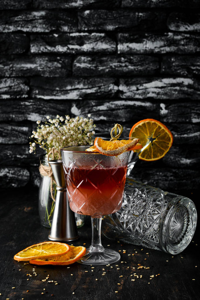 Hot cocktail. Rum, liquor and almond milk. On a black wooden background. Top view. Free copy space. - 写真・画像