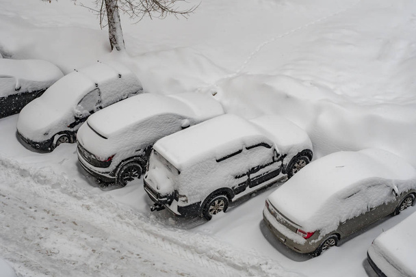 冬の嵐の後に雪に覆われた車のトップビュー - 写真・画像