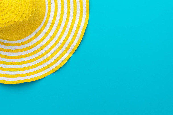 top view of yellow hat on blue background with copy space - Foto, immagini