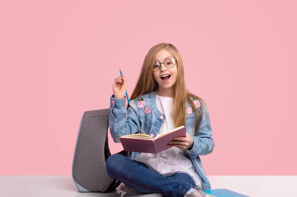 Trendy schoolgirl having idea for homework - Foto, immagini