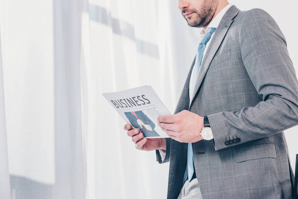 cropped view of businessman in suit holding newspaper in office with copy space - Photo, Image