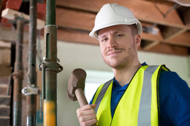 Portrait Of Construction Worker With Sledgehammer Demolishing Wa - Фото, зображення