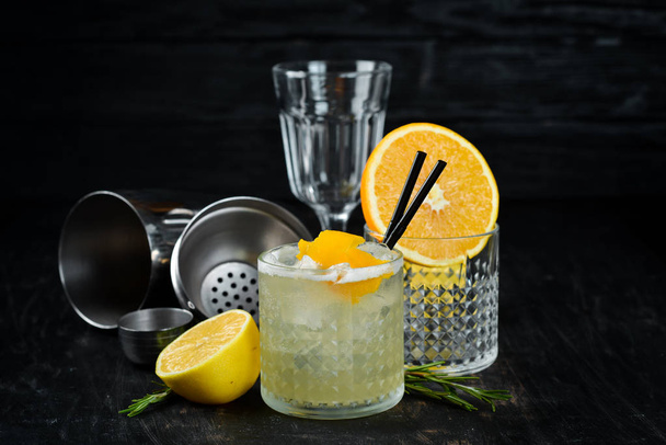 Cocktail Gin tonic with citrus in a glass. On a wooden background. Top view. Free copy space. - Фото, зображення