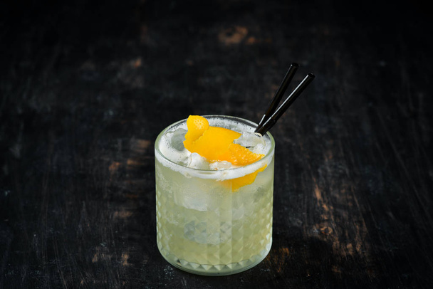 Cocktail Gin tonic with citrus in a glass. On a wooden background. Top view. Free copy space. - 写真・画像