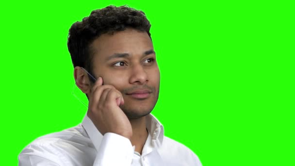 Cheerful Indian man talking on futuristic transparent phone. - Materiał filmowy, wideo