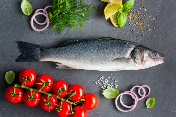 Labraks surowe ryby z składniki do gotowania ciepłe danie, widok z góry - Zdjęcie, obraz