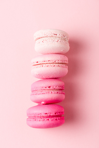 top view of colorul macarons on pink surface - 写真・画像