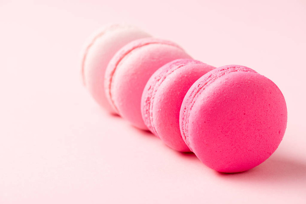 selective focus of sweet colorful macarons on pink surface - Fotó, kép