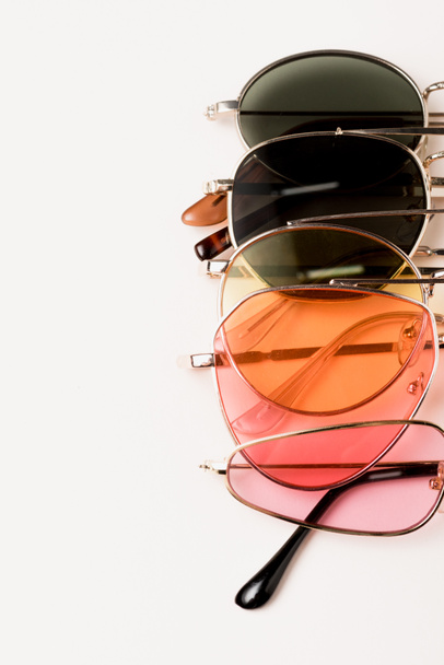 top view of stylish colorful sunglasses on white - Photo, Image