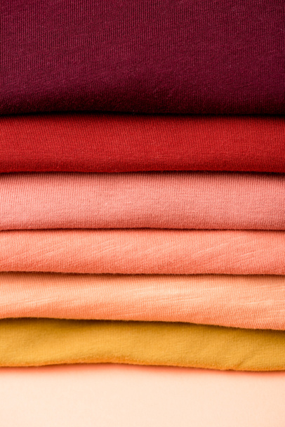 close up view of stack of folded colorful clothes - Foto, Imagem