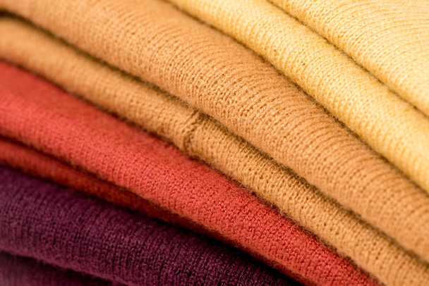 close up view of stack of folded colorful clothes - Foto, imagen
