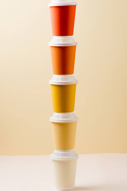 colorful disposable cups on light surface isolated on beige - Photo, Image