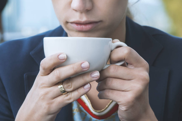 girl drinking cappuccino coffee in a cafe - Фото, зображення