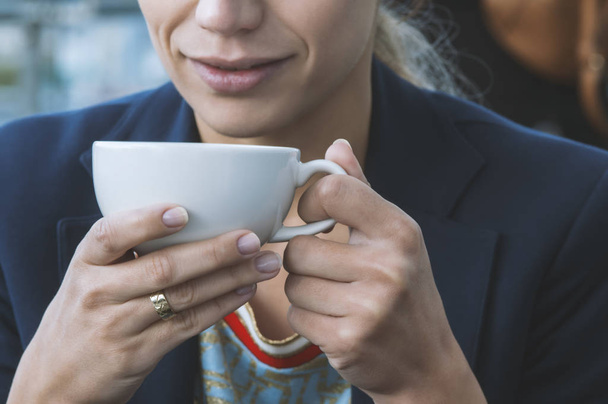 girl drinking cappuccino coffee in a cafe - Zdjęcie, obraz