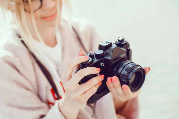 young beauty woman takes pictures on vintage camera, female photographer, chipster, street reporter - Photo, Image