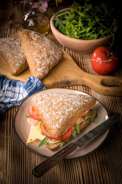 Triangular sandwich with cheese, ham and tomato. - Фото, зображення