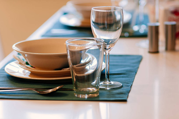 dining table set up with glasses, blue table cloth - Photo, Image