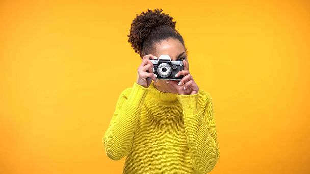 Young black woman making photo old-style camera, famous landmarks, sightseeing - Foto, imagen