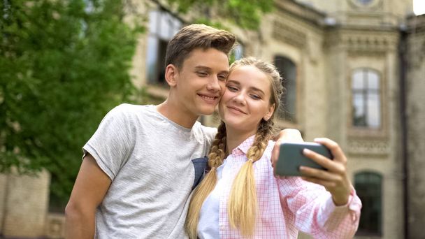 Teens making selfie against antique castle, place of interest, history studying - Photo, image