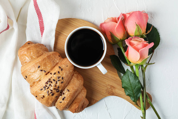 Composition with croissant, cup of coffee, roses and kitchen tow - Foto, imagen