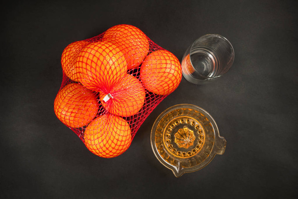 manual juicer and oranges on dark - Photo, Image