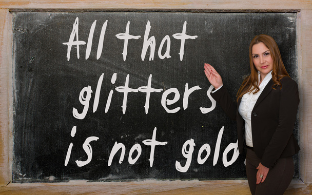 Teacher showing All that glitters is not gold on blackboard - Photo, Image