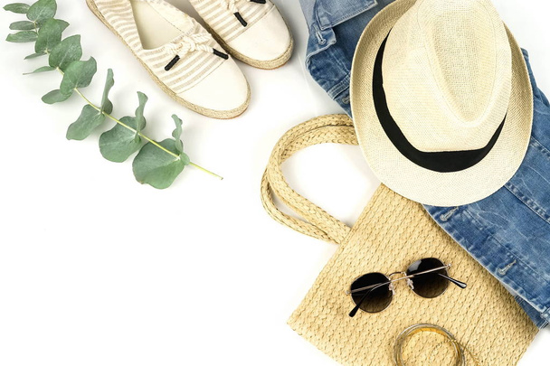 top view of straw hat, green plant and female stylish outfit on white background - Photo, Image