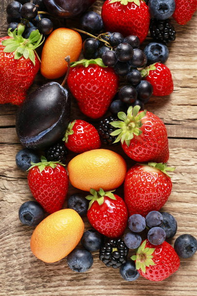 Delicious fruits: strawberry, grape, kumquat, blueberry and blac - Fotoğraf, Görsel