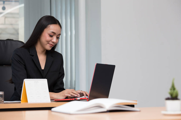 Shot of an Asian businesswoman working on laptop in the office - Fotografie, Obrázek