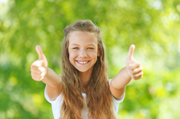 teenage girl lifts thumb upwards - Photo, image