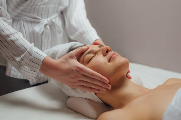 Woman Enjoying a Facial Massage - Fotografie, Obrázek
