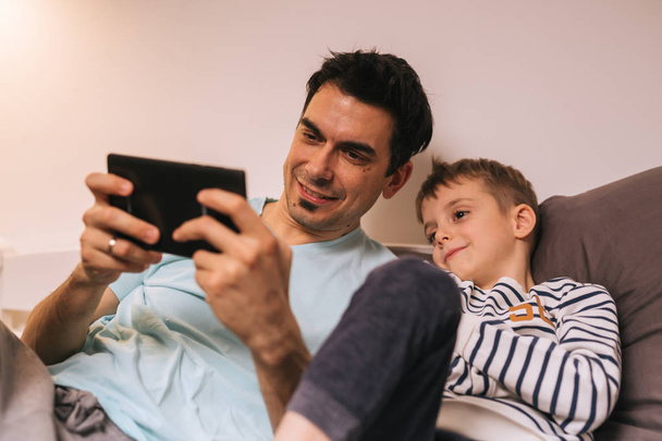 father and son playing games together. - 写真・画像