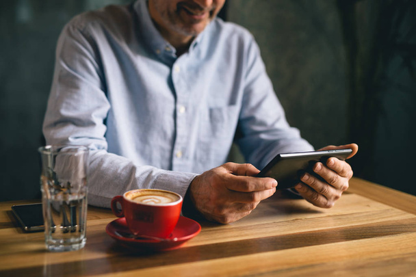 Coffee break concept, closeup of man using tablet in cafe bar. - Φωτογραφία, εικόνα